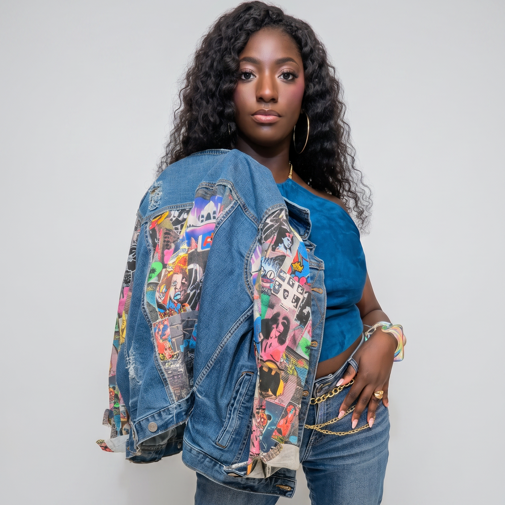 A woman modeling a heavily decorated distressed denim jacket covered in colorful stickers and patches, paired with blue jeans, a blue top, and colorful high heels, against a light gray studio background.
