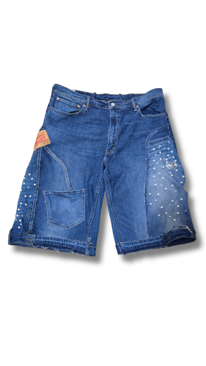 Blue denim shorts with a brand label on a white background